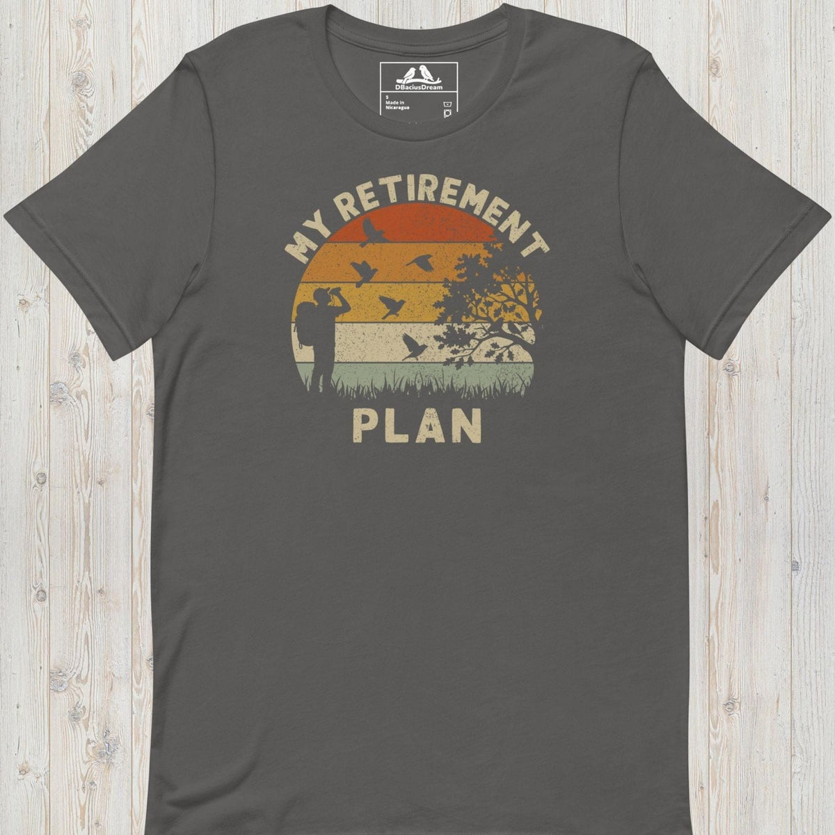 Gray birding my retirement plan t-shirt with a vintage sunset graphic, a birder, and flying birds