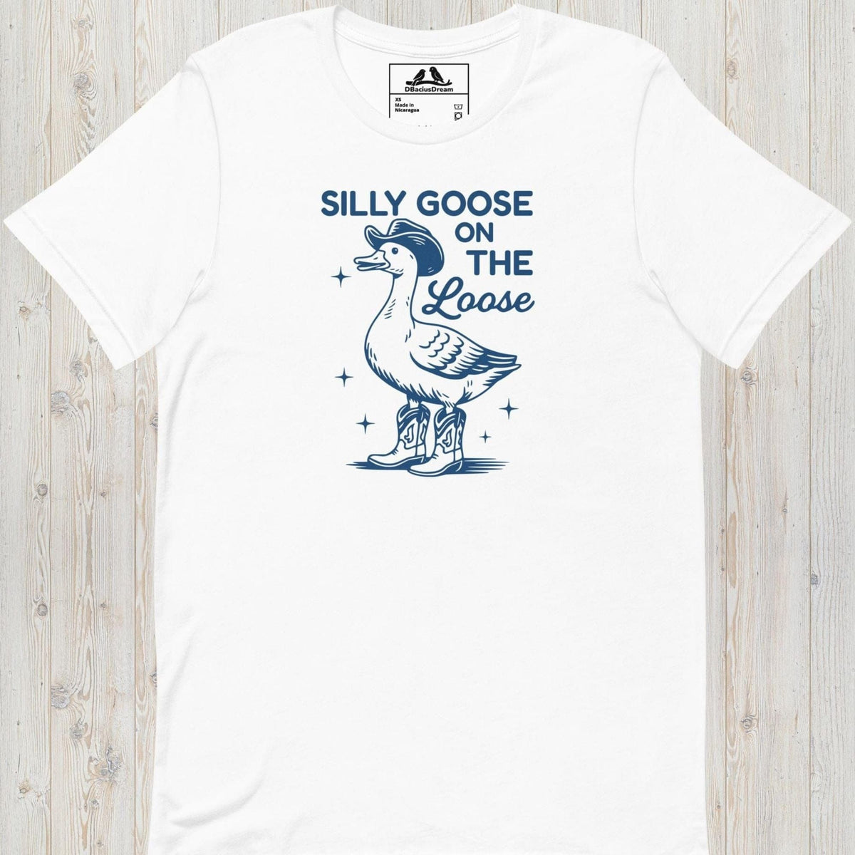 White silly goose on the loose t-shirt with a playful goose illustration and the humorous quote "Silly Goose On The Loose"