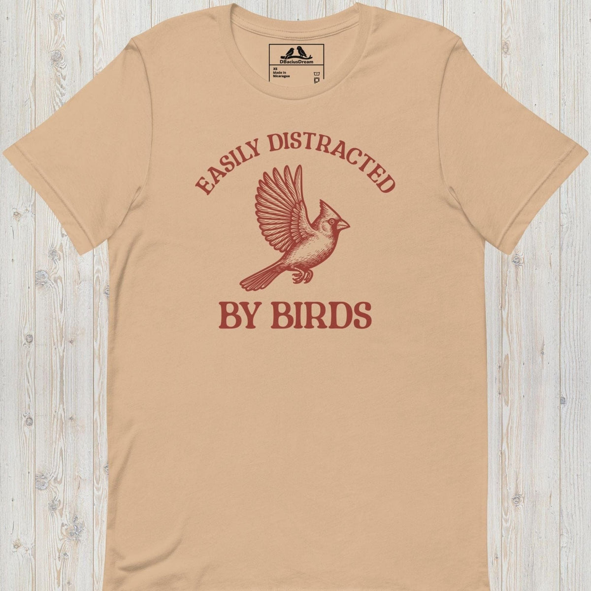 Beige Easily Distracted By Birds T-Shirt with vintage flying bird graphic and text design