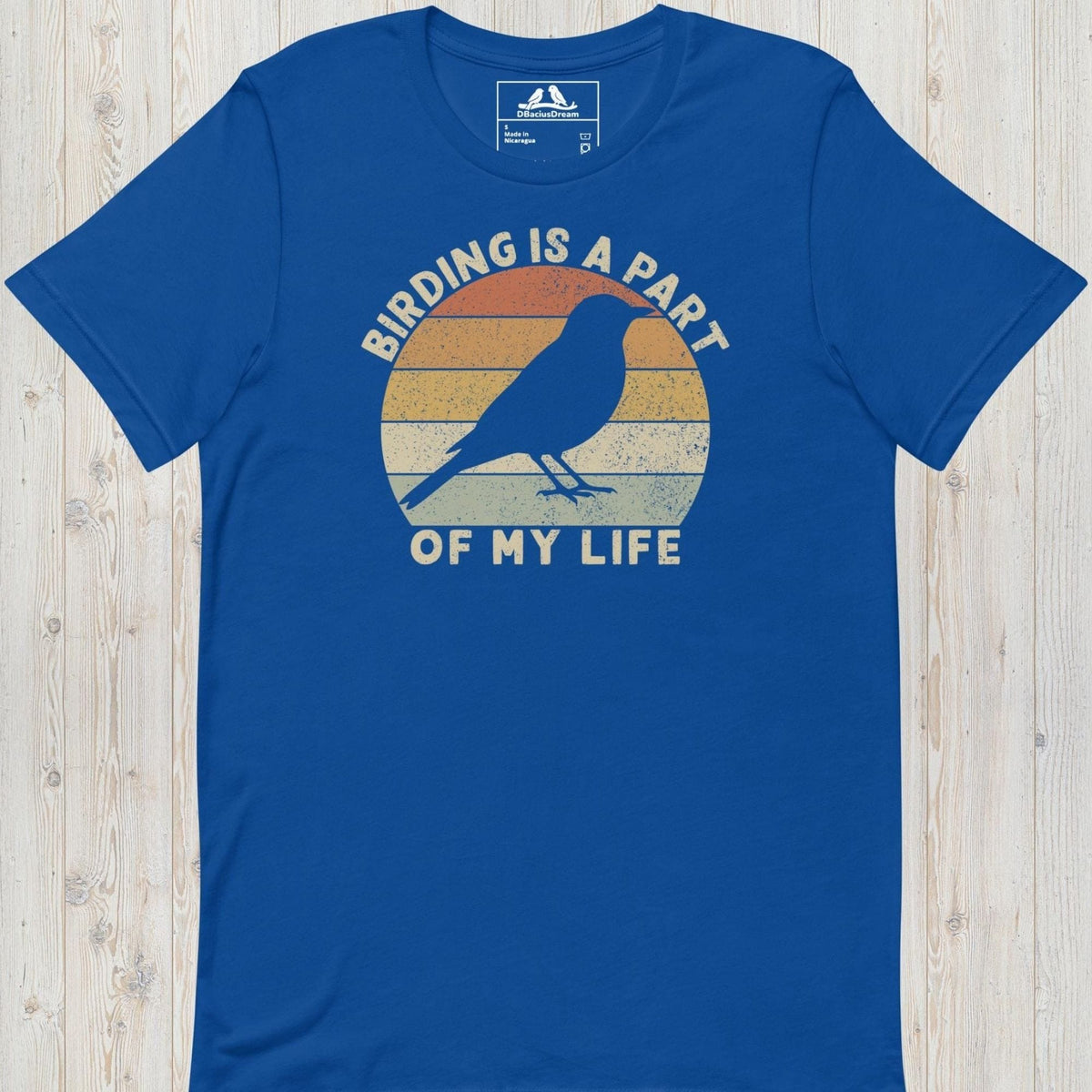 Blue bird lover t-shirt with a vintage sunset graphic, bird silhouette and the quote "Birding Is A Part Of My Life"