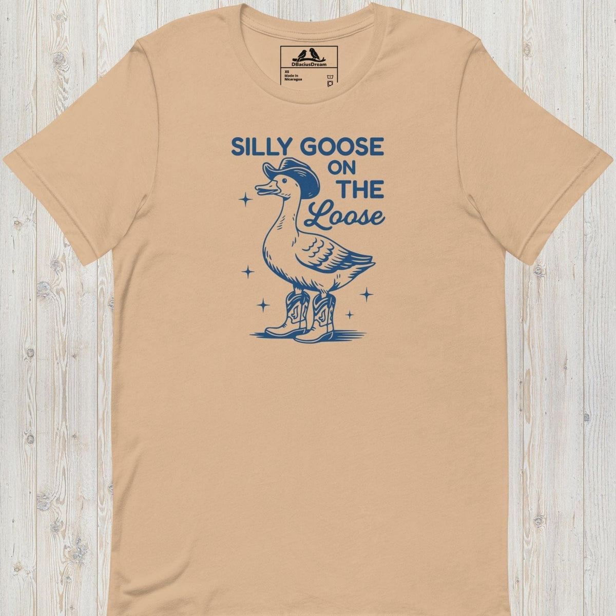 Beige silly goose on the loose t-shirt with a playful goose illustration and the humorous quote "Silly Goose On The Loose"