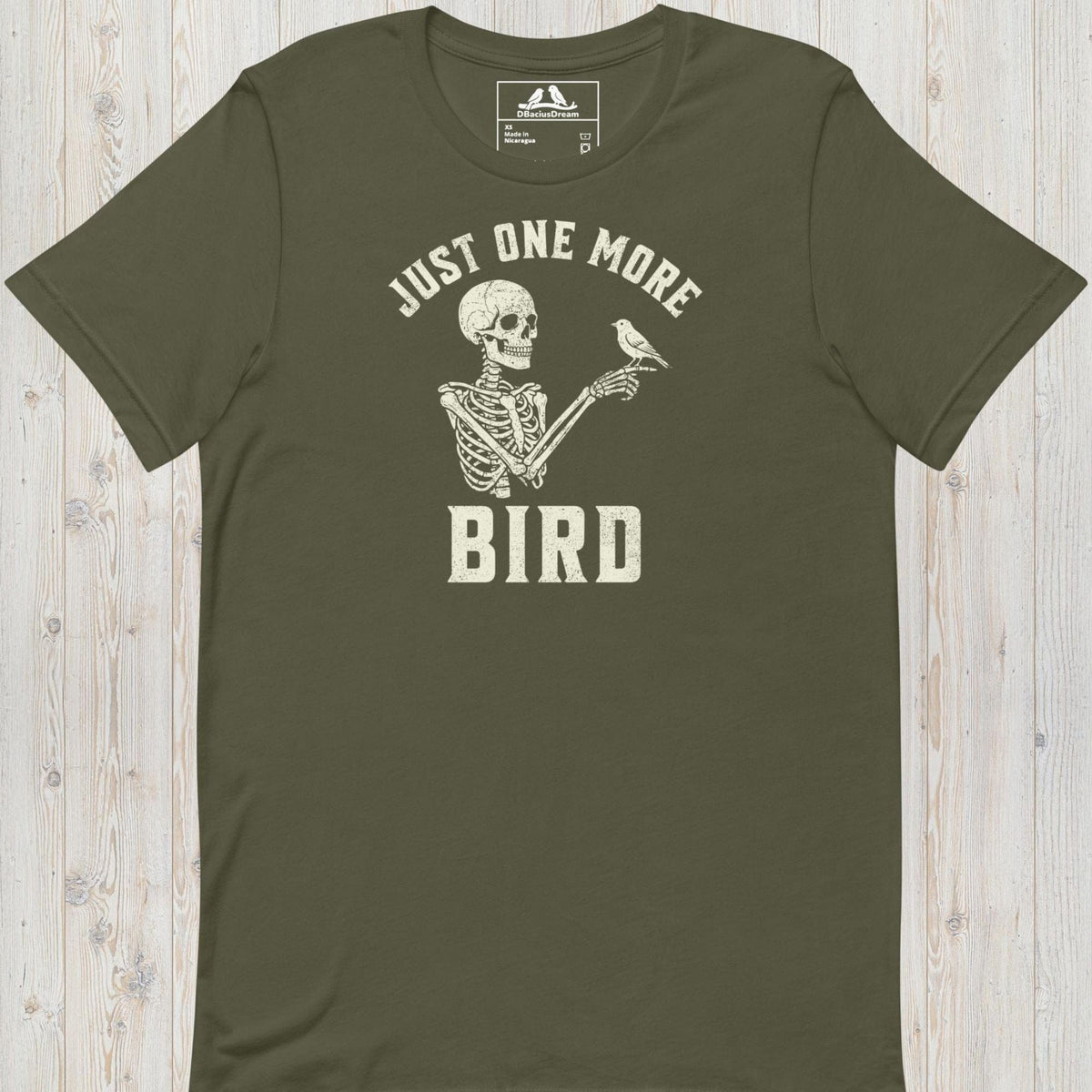 Olive green just one more bird t-shirt with a skeleton birder graphic and the quote "Just One More Bird"
