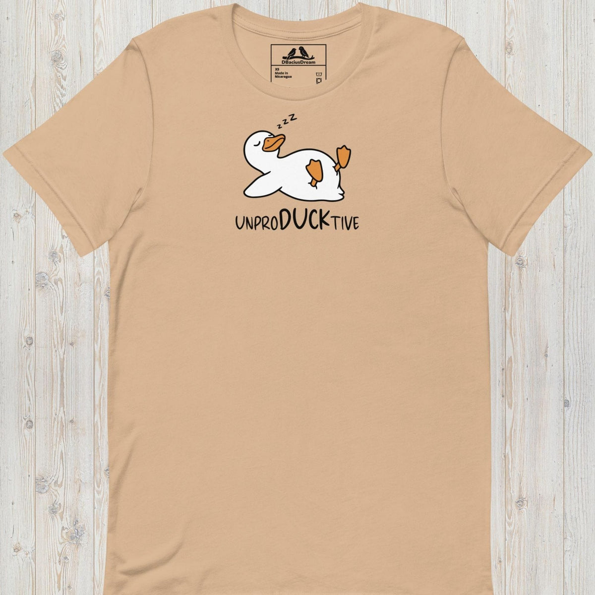 Beige funny duck t-shirt featuring a lazy duck lying on its back and the text "UnproDUCKtive"
