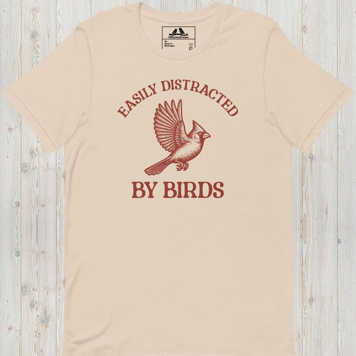 Light beige Easily Distracted By Birds T-Shirt with vintage flying bird graphic and text design