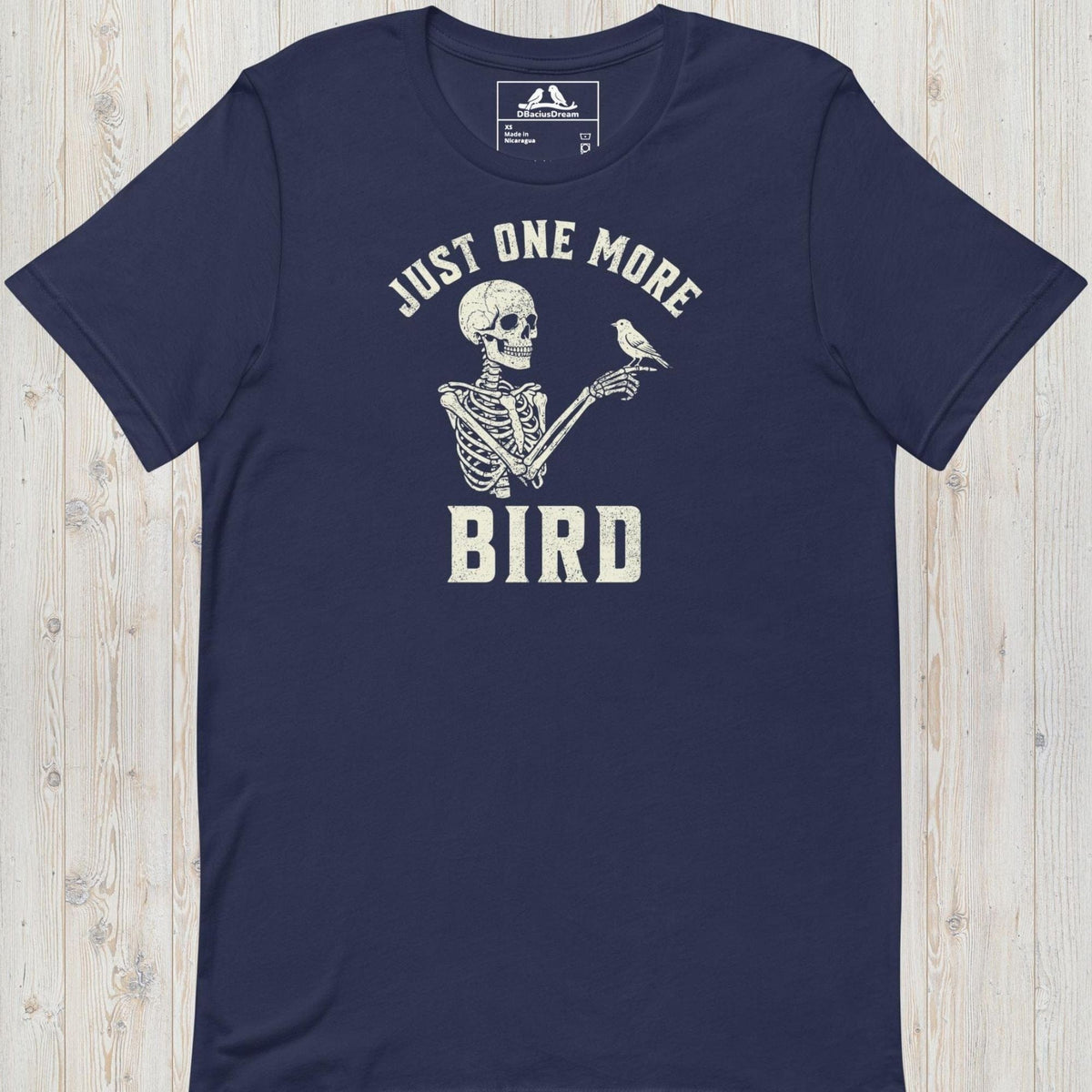 Dark blue just one more bird t-shirt with a skeleton birder graphic and the quote "Just One More Bird"