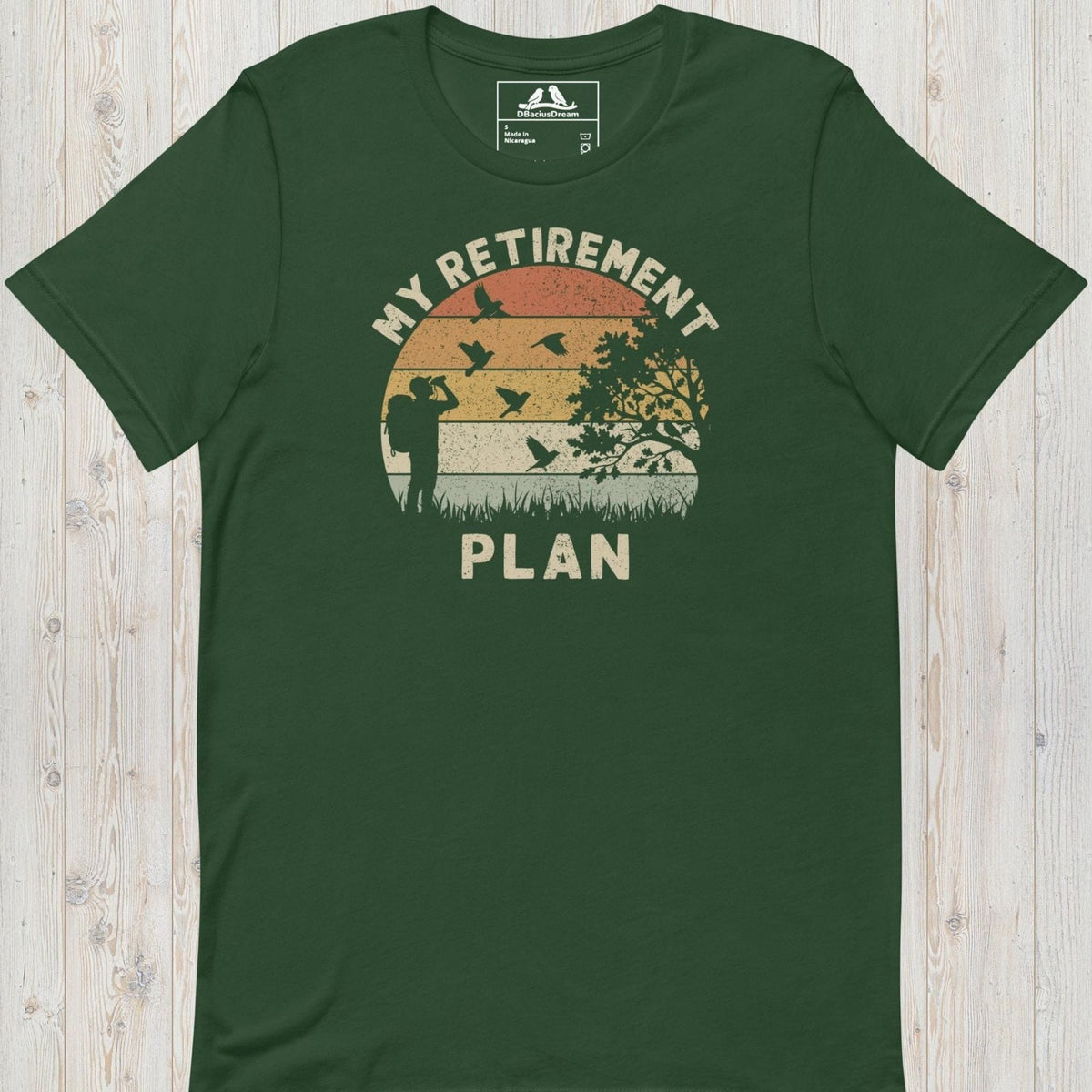 Green birding my retirement plan t-shirt with a vintage sunset graphic, a birder, and flying birds