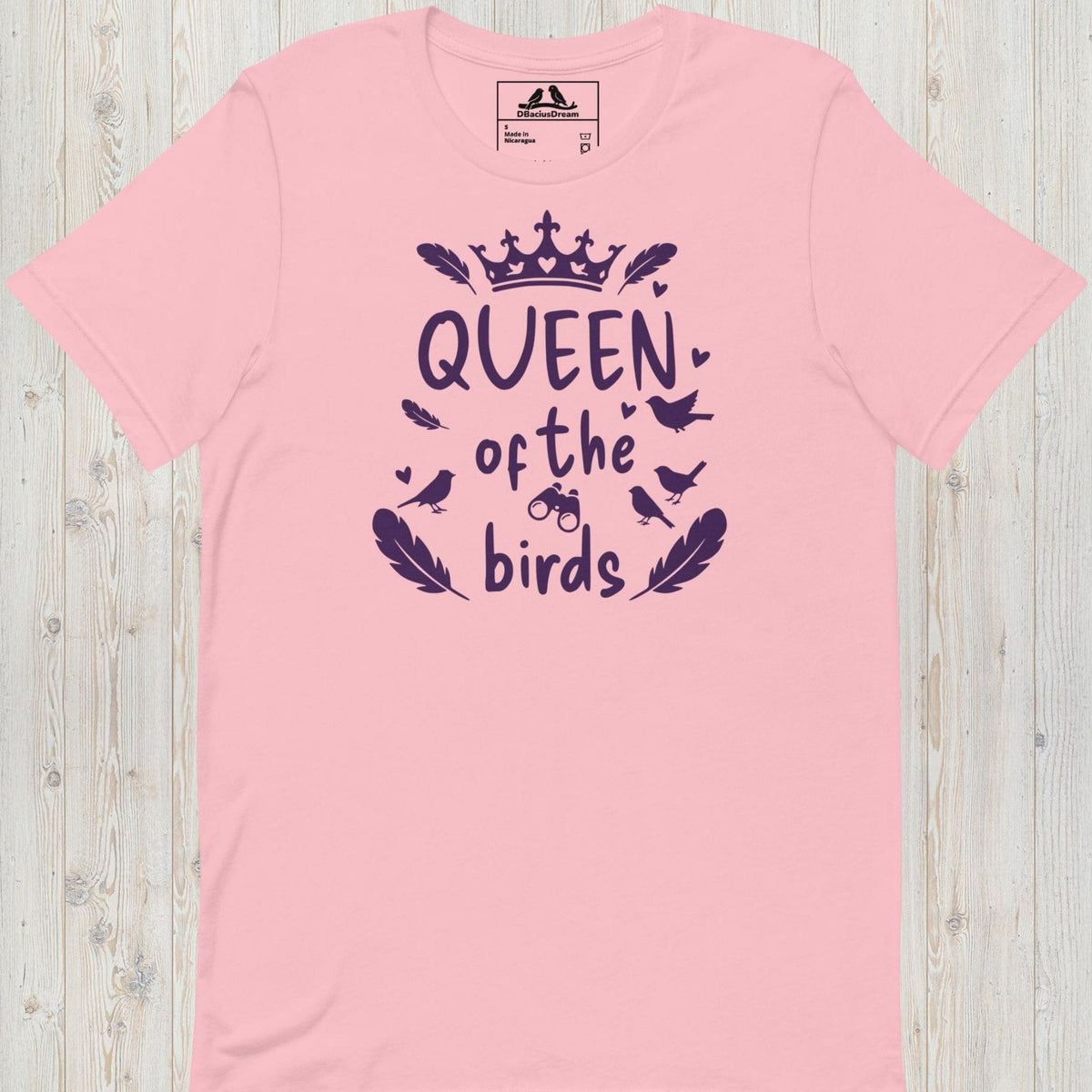 Pink queen of the birds t-shirt with a purple bird graphic, crown design and decorative bird silhouettes