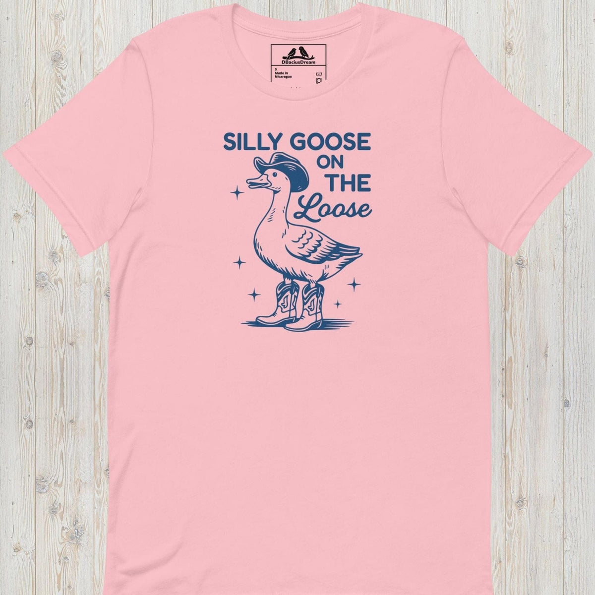 Pink silly goose on the loose t-shirt with a playful goose illustration and the humorous quote "Silly Goose On The Loose"