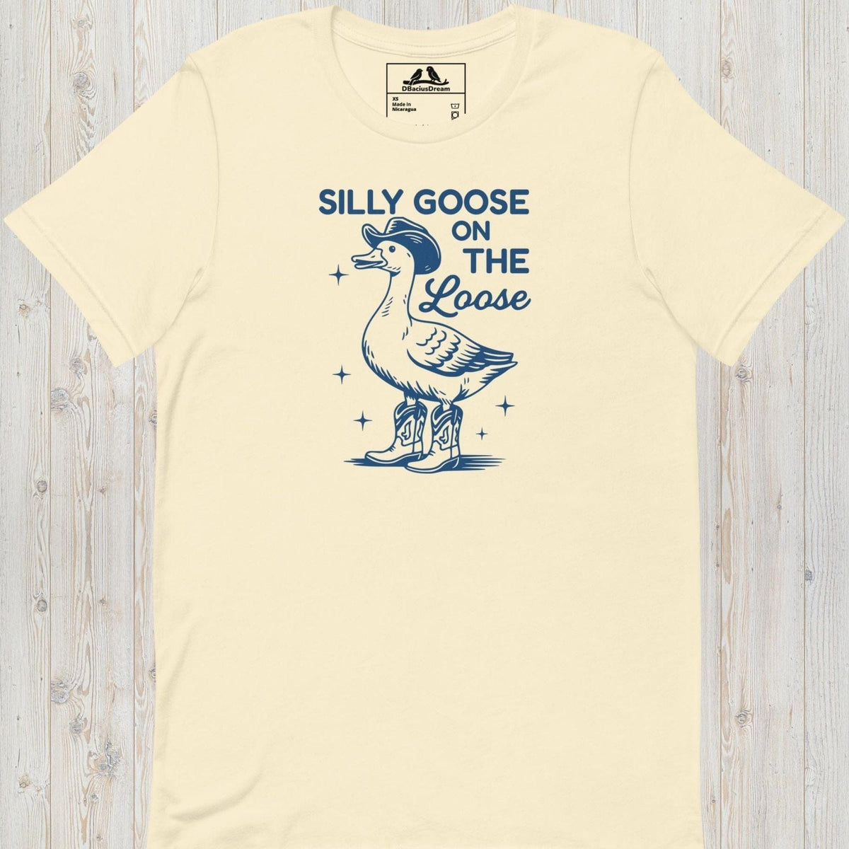 Cream silly goose on the loose t-shirt with a playful goose illustration and the humorous quote "Silly Goose On The Loose"