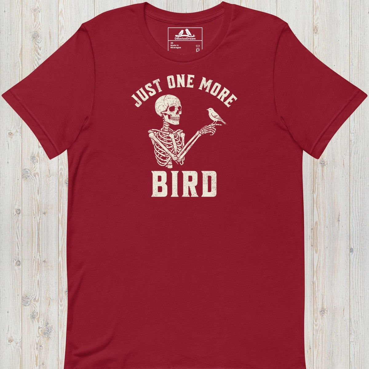 Red just one more bird t-shirt with a skeleton birder graphic and the quote "Just One More Bird"