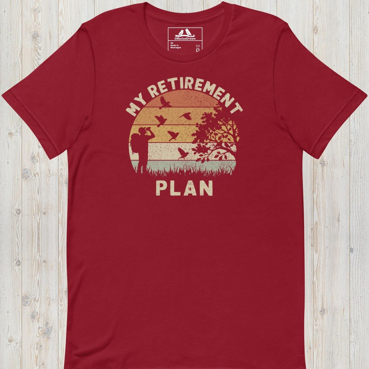 Red birding my retirement plan t-shirt with a vintage sunset graphic, a birder, and flying birds