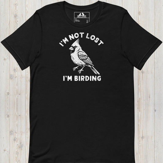 Black funny birding t-shirt featuring a northern cardinal and "I'm Not Lost I'm Birding" text
